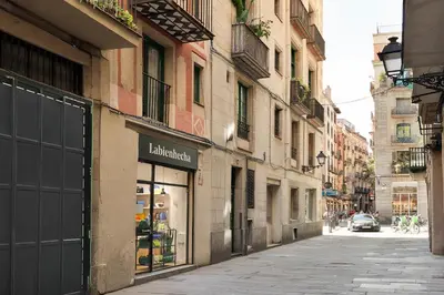an empty street with a shop on the side of a building at Ola Living Vidreria in Barcelona