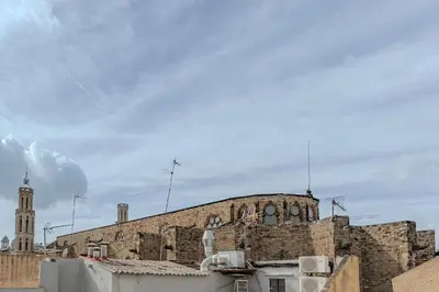 an old building with a clock tower on top of it at Ola Living Vidreria in Barcelona