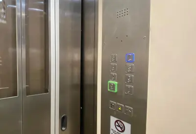 a close up of a metal elevator with buttons at Fisa Rentals Aribau in Barcelona