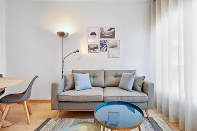 a living room with a couch and a table at Fisa Rentals Aribau in Barcelona
