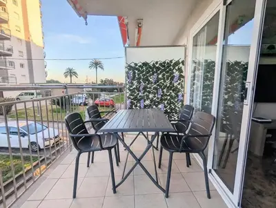 a small room with a bed and a refrigerator at Spacious apartment in Cabrera de Mar with sea view in Cabrera de Mar