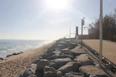 a row of rocks on the beach at Spacious apartment in Cabrera de Mar with sea view in Cabrera de Mar