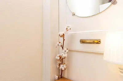 a bunch of flowers on a door with a mirror at Cal Mateu 11 huéspedes - Sagrada Família in Barcelona
