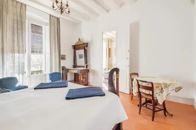 a bedroom with a bed and a table and chairs at Can Rovira - Stunning Neoclassical Mansion, Just 20 min drive from Barcelona City Center, Ideal for groups and families in Alella