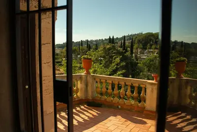 a balcony with vases on a railing with a view at Can Rovira - Stunning Neoclassical Mansion, Just 20 min drive from Barcelona City Center, Ideal for groups and families in Alella