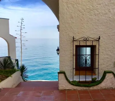 a building with a window with a view of the ocean at The Magic Sea Front by Hello Homes Sitges in Sitges
