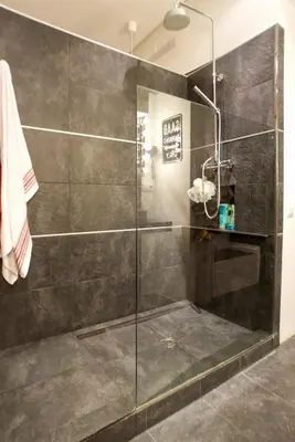 a shower with a glass door in a bathroom at Loft en Gràcia ArchsenseApartments in Barcelona