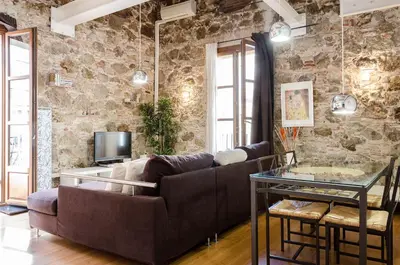 a living room with a couch and a glass table at Loft en Gràcia ArchsenseApartments in Barcelona