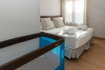 a bedroom with a bed with a blue dresser at Amister Apartments in Barcelona