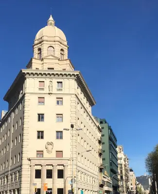 a tall white building with a tower on top of it at Amister Apartments in Barcelona