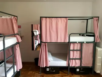 two bunk beds in a room with a mirror at Mucha Masia Hostel Rural Urba in El Prat de Llobregat