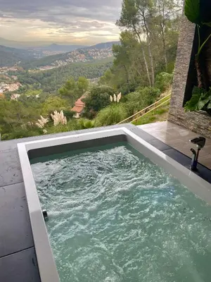 a swimming pool with a view of the mountains at Petit Mirador in Torrelles de Llobregat