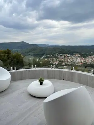 two white benches sitting on top of a balcony at Petit Mirador in Torrelles de Llobregat