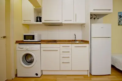 a kitchen with a washing machine and a microwave at Barcelona City Apartment in Barcelona