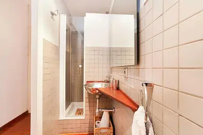 a bathroom with a sink and a mirror at Gracia Apartment in Barcelona