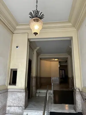 a chandelier hangs from the ceiling of a building at Gracia Apartment in Barcelona