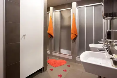 a bathroom with a sink and a toilet and a shower at Hip Karma Hostel in Barcelona