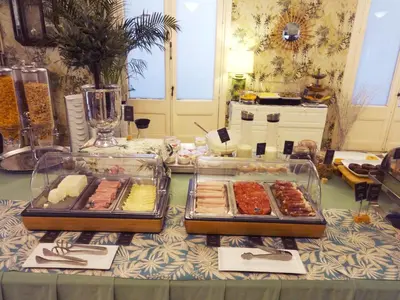 a table with several trays of food on it at Hotel Lloret Ramblas in Barcelona