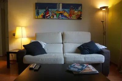 a living room with a couch and a table at ApartEasy - Montjuïc & Fira in Barcelona