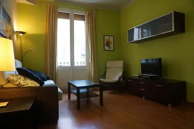 a living room with a couch and a tv at ApartEasy - Montjuïc & Fira in Barcelona