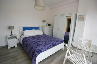 a bedroom with a bed and a table and a chair at ApartEasy - Plaza España Deluxe in Barcelona
