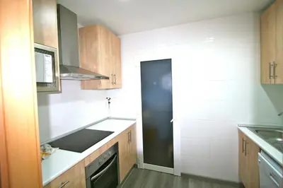 a small kitchen with a sink and a stove at ApartEasy - Plaza España Deluxe in Barcelona