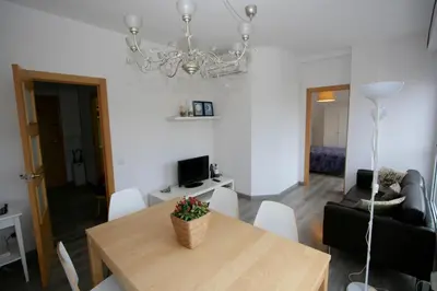 a dining room with a table and a chandelier at ApartEasy - Plaza España Deluxe in Barcelona