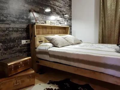 a bedroom with a bed and a brick wall at Apartment Beach Front Canet in Canet de Mar
