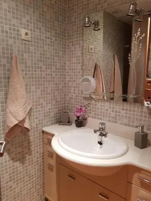 a bathroom with a sink and a mirror at Apartment Beach Front Canet in Canet de Mar