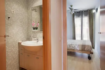 a bathroom with a sink and a mirror at Apartment Beach Front Canet in Canet de Mar