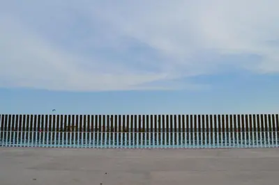 a metal fence with a blue sky in the background at Hotel Boutique dONNA in Castelldefels