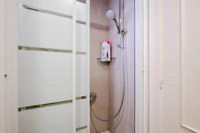 a bathroom with a shower with a blow dryer at Three Bedroom Apartment in Sants in Barcelona