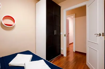 a bedroom with a bed and a black door at Three Bedroom Apartment in Sants in Barcelona