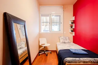 a small room with a bed and a chair at Three Bedroom Apartment in Sants in Barcelona