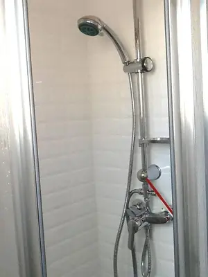 a shower with a shower head in a bathroom at Unique studio Apartment with amazing terrace Sitges centre beach in Sitges