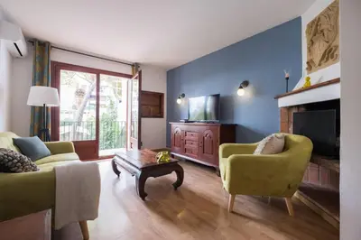 a living room with two couches and a tv at 3 bedroom Apartment with private garden on top location Sitges centre beach in Sitges