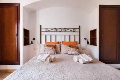 a bedroom with a large bed with two towels on it at 3 bedroom Apartment with private garden on top location Sitges centre beach in Sitges