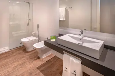 a bathroom with a sink and a toilet and a mirror at Apartments Playa de Castelldefels in Castelldefels
