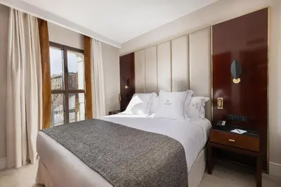 a bedroom with a large bed and a window at Suites Center Barcelona in Barcelona