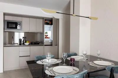 a dining room with a table with plates and wine glasses at Suites Center Barcelona in Barcelona