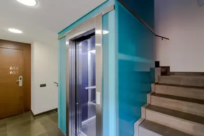 a hallway with a blue wall and stairs at Suites Center Barcelona in Barcelona