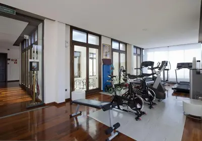 a gym with two bikes parked in a room at Suites Center Barcelona in Barcelona