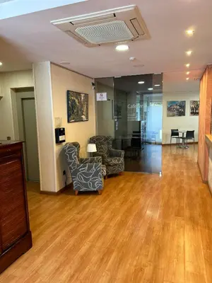 an empty lobby with chairs and tables in a building at Hotel 1948 Manresa in Manresa
