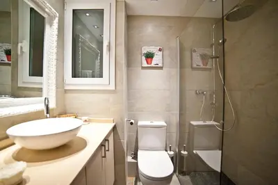 a bathroom with a sink and a toilet and a shower at Tendency Sagrada Familia Deluxe in Barcelona