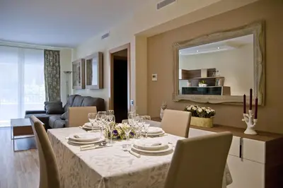 a dining room with a table with chairs and a mirror at Tendency Sagrada Familia Deluxe in Barcelona