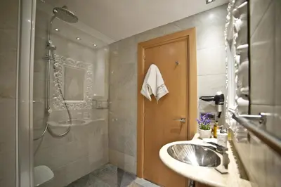 a bathroom with a sink and a shower at Tendency Sagrada Familia Deluxe in Barcelona