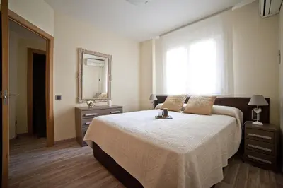 a bedroom with a large bed and a mirror at Tendency Sagrada Familia Deluxe in Barcelona
