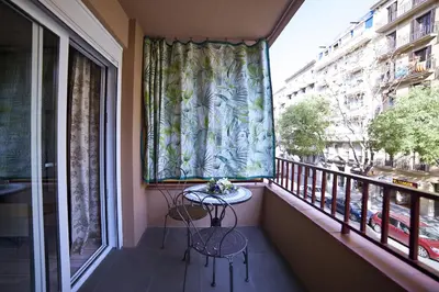 a balcony with two chairs and a table in a window at Tendency Sagrada Familia Deluxe in Barcelona