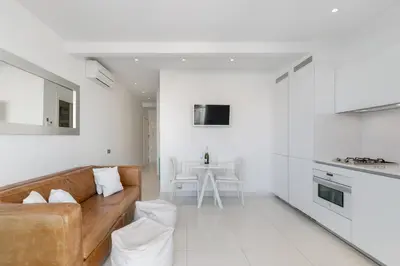 a living room with a couch and a table at Beach penthouse Sitges Rentals in Sitges