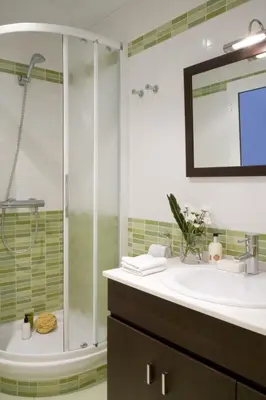 a bathroom with a shower and a sink and a tub at ApartEasy - Sant Antoni Market in Barcelona